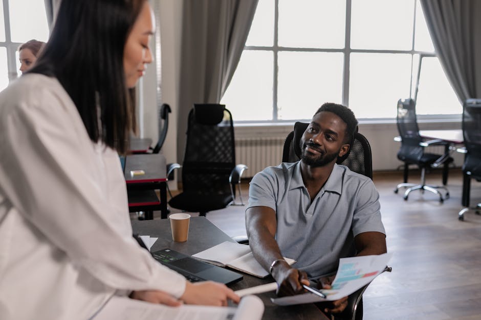 Diverse team discusses strategy in a modern conference room setting.